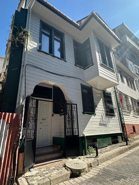 a white house with a white door on a street at WOODEN House ÜSKÜDAR in Istanbul