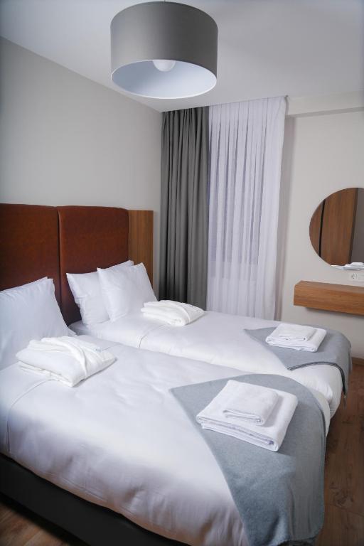 Postel nebo postele na pokoji v ubytování Eikon Apartments Abastumani
