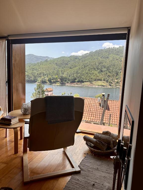 a living room with a view of a large window at Casa do Bairro da Veiga in Pereiro