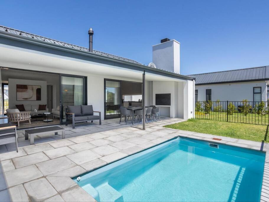 a swimming pool in the backyard of a house at Luxury Villa 712 Pearl Valley Golf Estate in Paarl