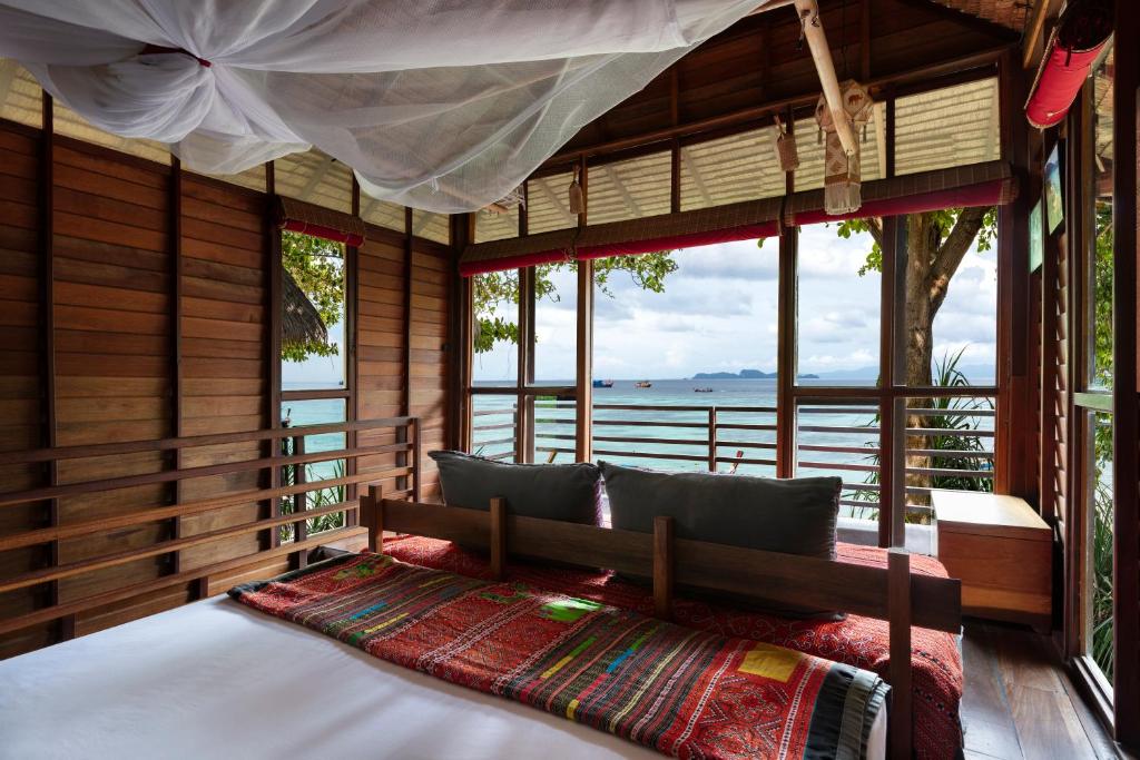 a bedroom with a bed with a view of the ocean at Castaway Resort Koh Lipe in Ko Lipe