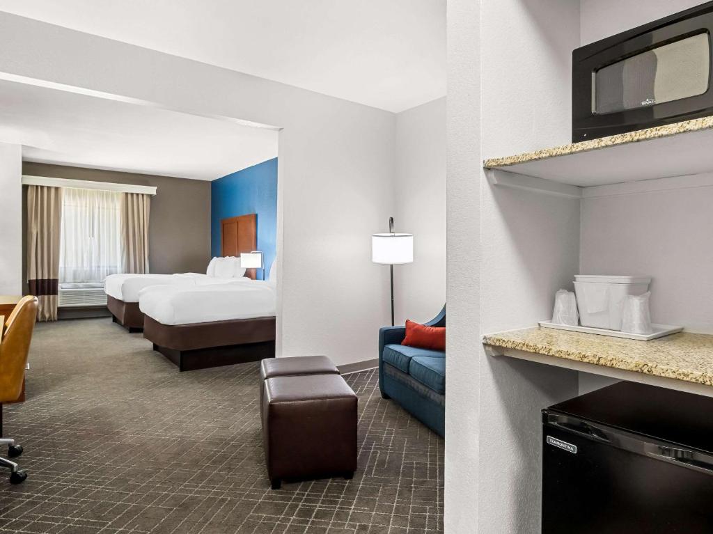 a hotel room with two beds and a tv at Comfort Suites Lindale in Lindale