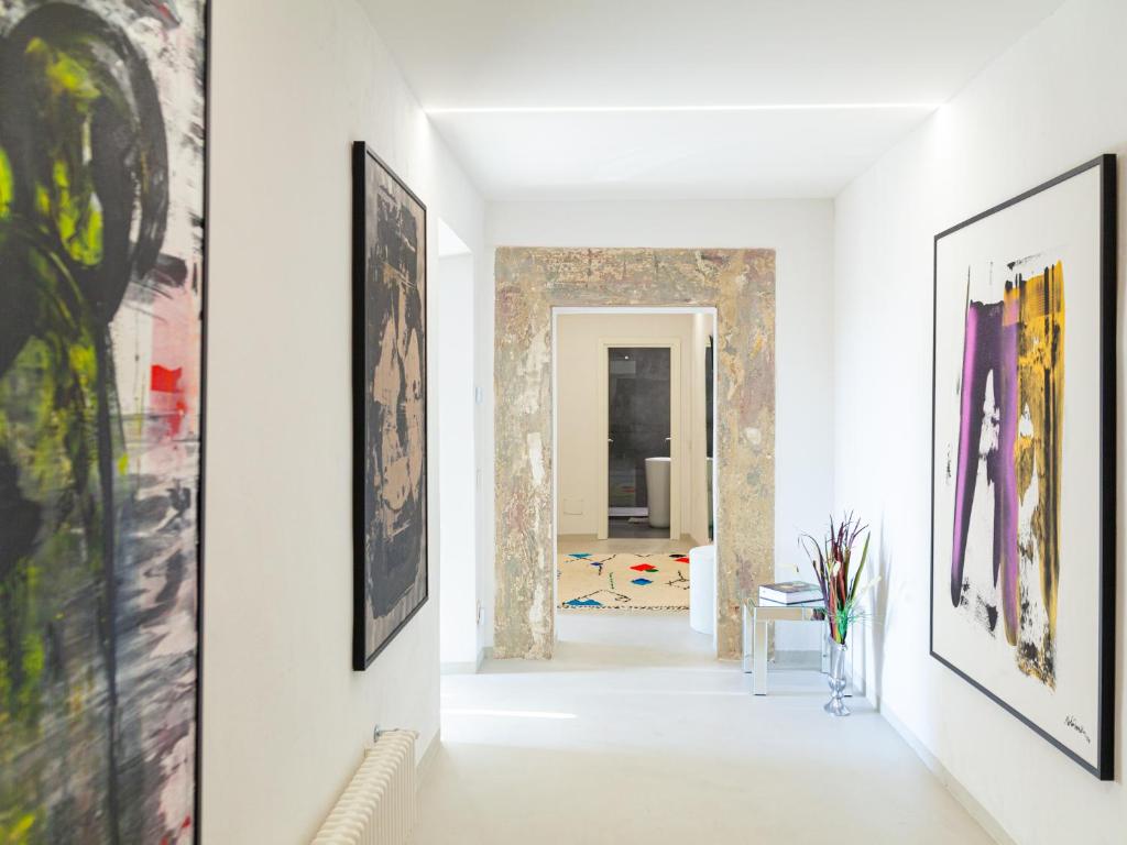 a hallway with paintings on the walls at Palace d'Art - Centro Storico di Arezzo in Arezzo