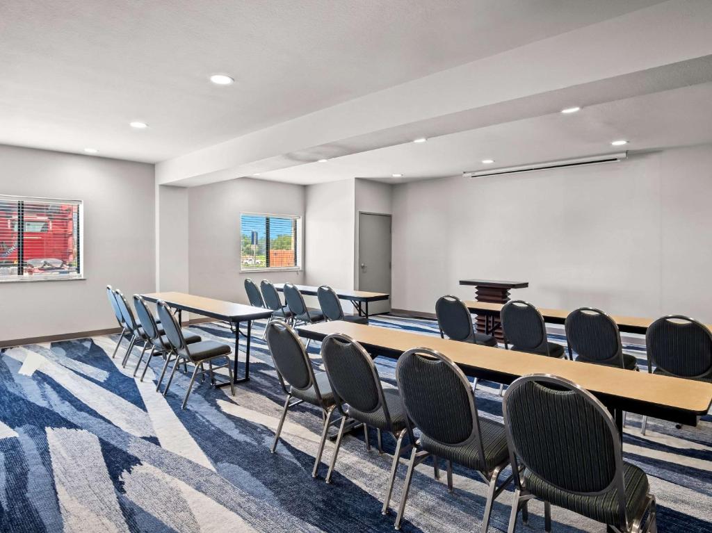 a conference room with tables and chairs and a whiteboard at Comfort Suites Lindale in Lindale