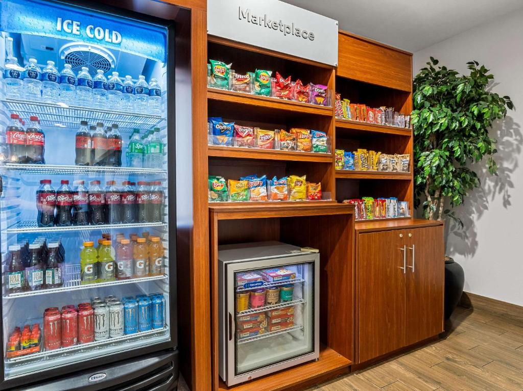 a refrigerator filled with lots of drinks in a store at Comfort Suites Lindale in Lindale
