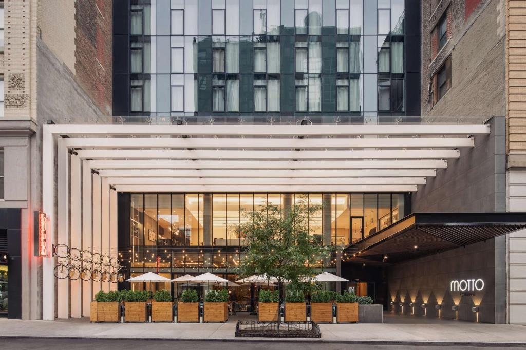 a large entrance to a building with umbrellas at Motto by Hilton New York City Chelsea in New York