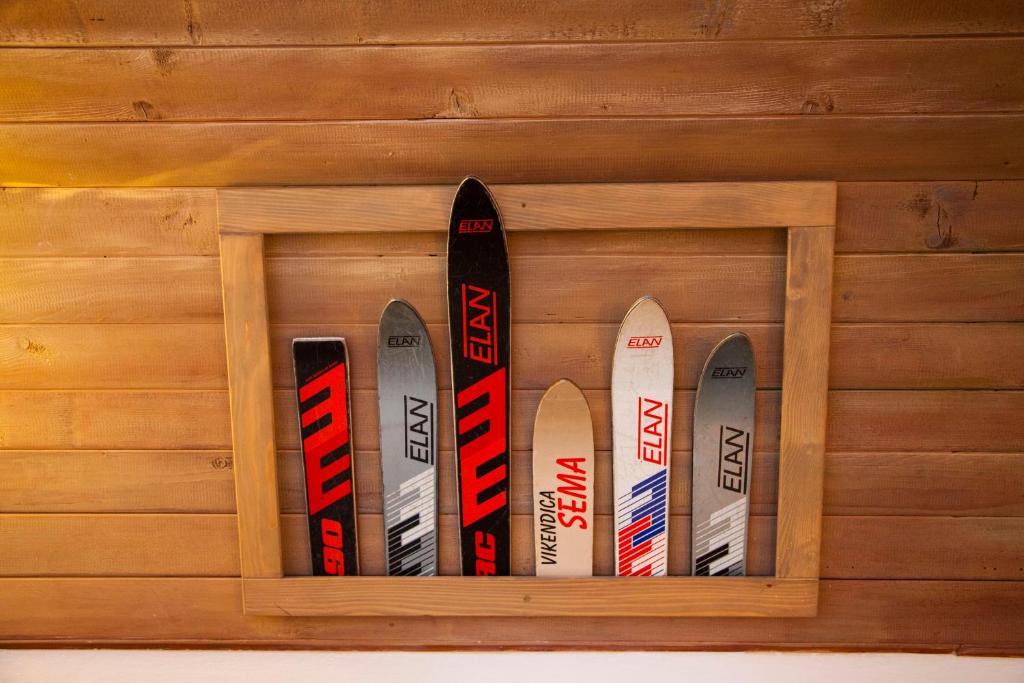 a row of skis in a wooden wall at Apartments Sema in Jahorina