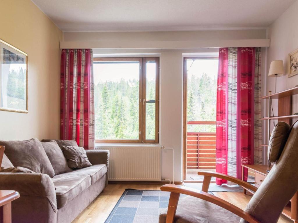 a living room with a couch and a window at Holiday Home Ylläs chalets a507 by Interhome in Ylläsjärvi