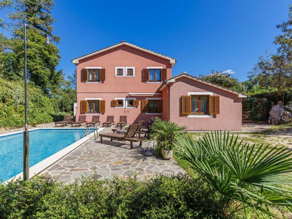 a villa with a swimming pool and a house at Apartment Vinka by Interhome in Žminj