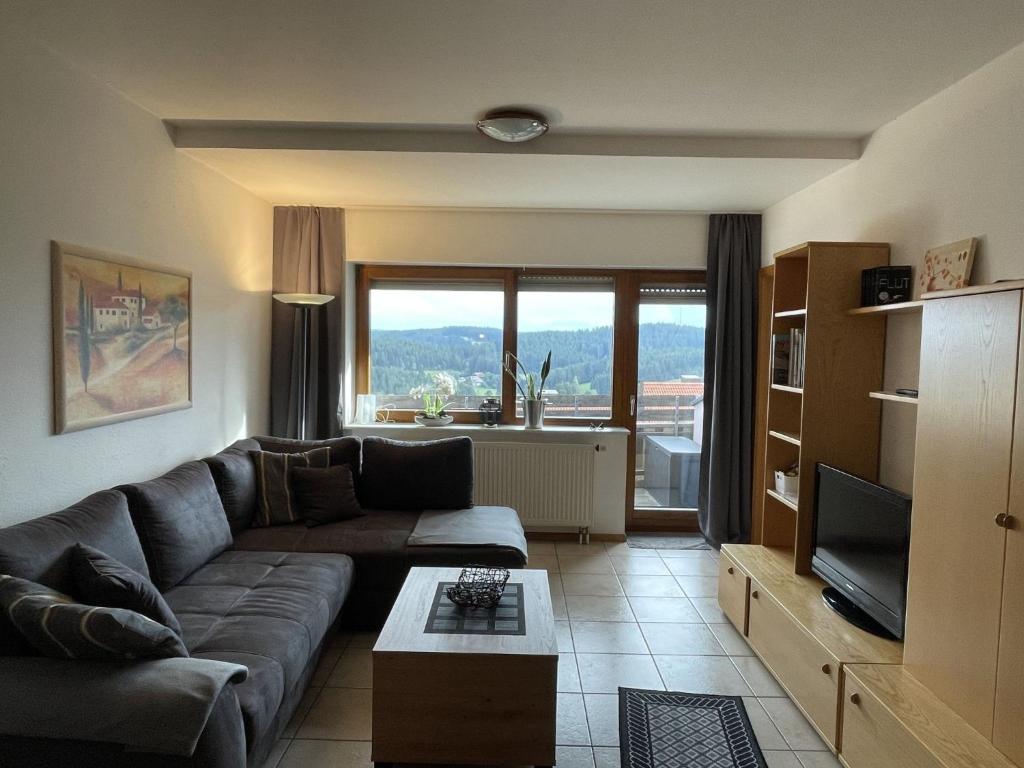 a living room with a couch and a television at Apartment Schwarzwaldblick-27 by Interhome in Obertal
