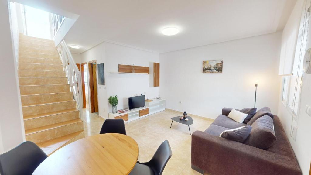 una sala de estar con un sofá y una mesa en Holidoo Casa Marbella, en Los Alcázares