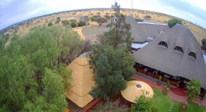 an aerial view of a large building with a field at Kalahari Lodge Kimberley in Kimberley