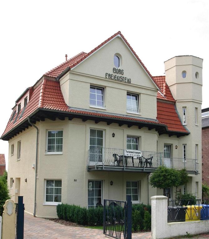 a large white building with a red roof at Burg Freienstein in Rostock