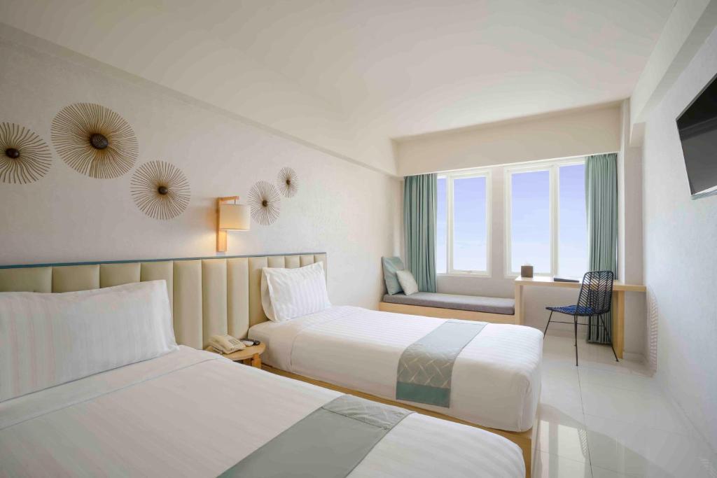 Postel nebo postele na pokoji v ubytování Solaris Hotel Kuta