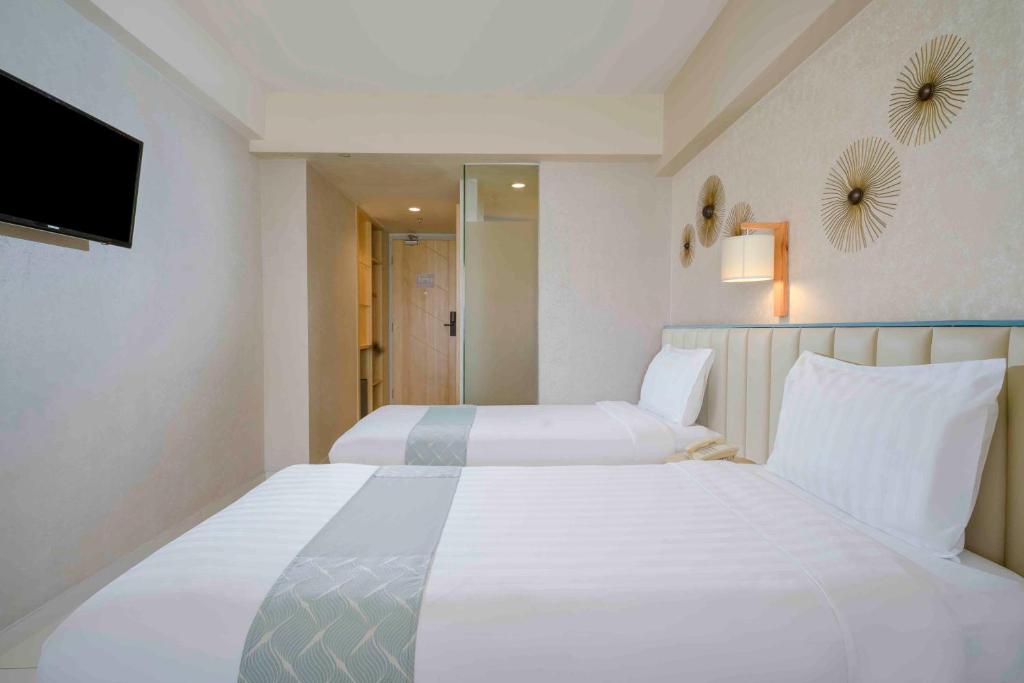 Postel nebo postele na pokoji v ubytování Solaris Hotel Kuta