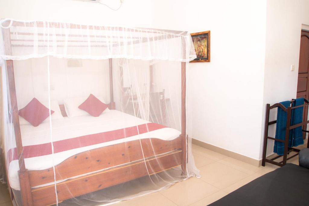 Postel nebo postele na pokoji v ubytování Angel Inn Guest House