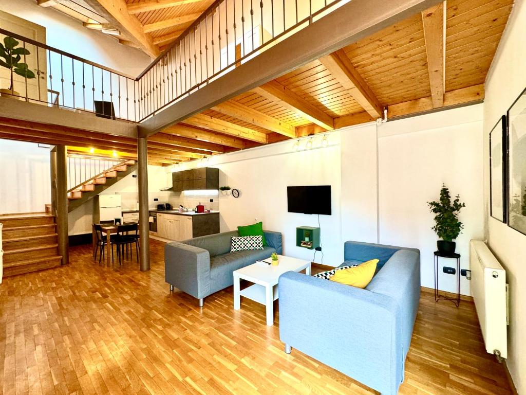 a living room with two blue couches and a table at Little Loft in Timişoara