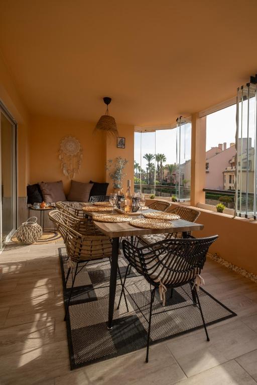 salon ze stołem, krzesłami i kanapą w obiekcie Aquamarine apartment in Marina Sotogrande w mieście Sotogrande