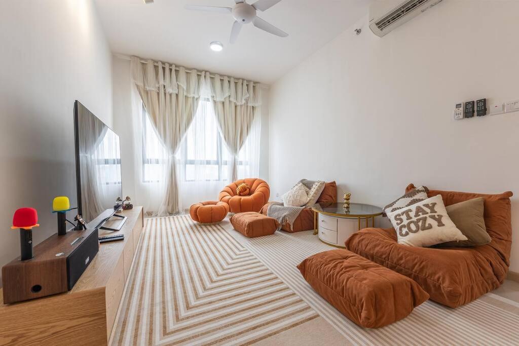 a living room with a couch and a tv at Cheras Kuala Lumpur luxury condo in Cheras