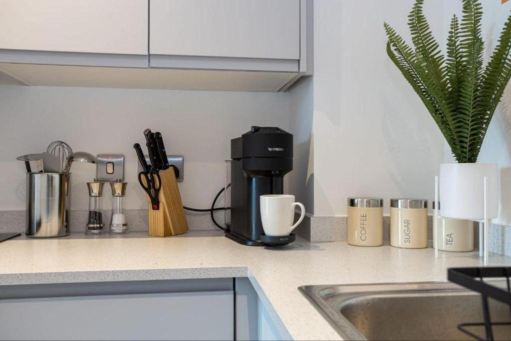 a kitchen counter with a coffee maker and utensils at Warrington - House - Sleeps 6 - Parking - Garden in Warrington