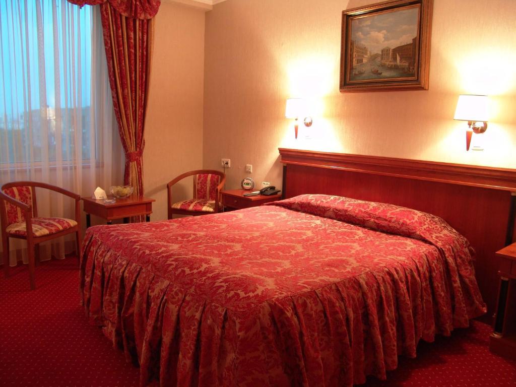 Postel nebo postele na pokoji v ubytování Mirage Hotel