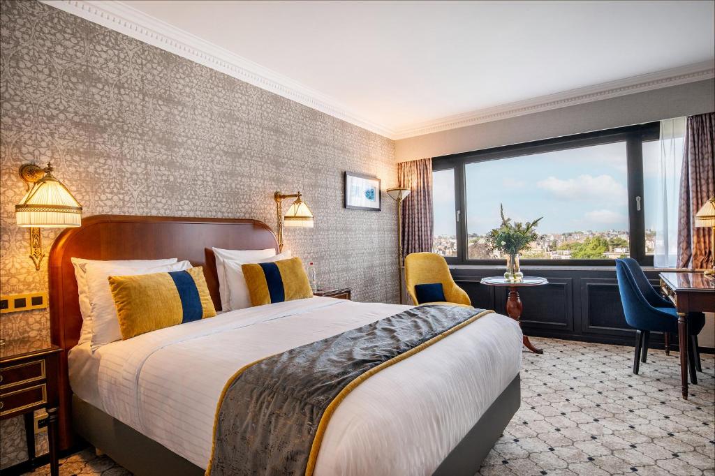 a hotel room with a bed and a large window at Hotel Barsey by Warwick in Brussels
