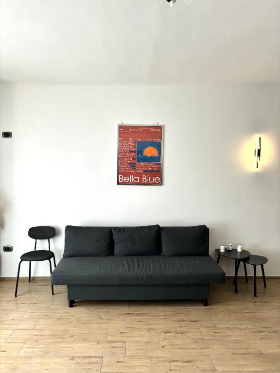 a living room with a couch and two tables at Bella Blue B&B in Bisceglie