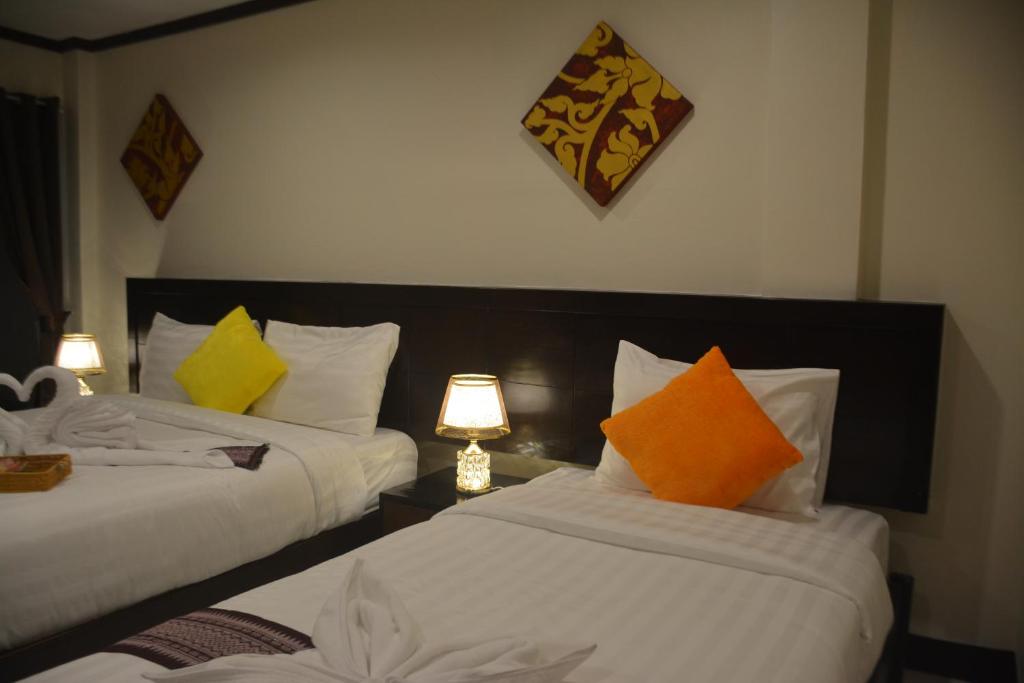 Postel nebo postele na pokoji v ubytování Patong Moon Inn Residence