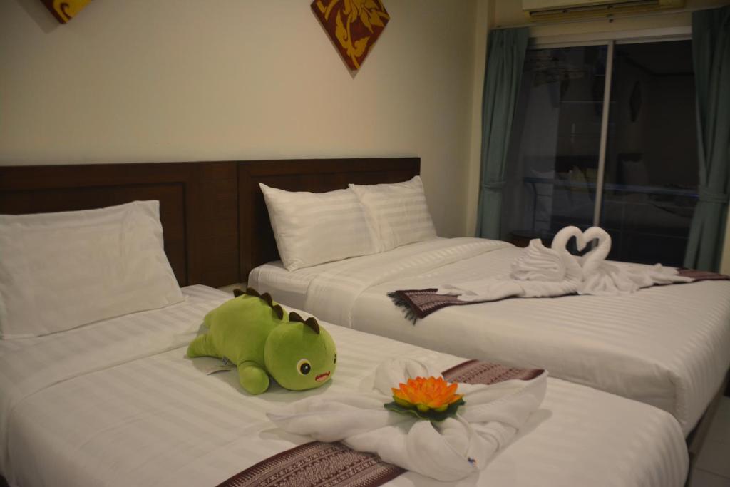 Postel nebo postele na pokoji v ubytování Patong Moon Inn Residence