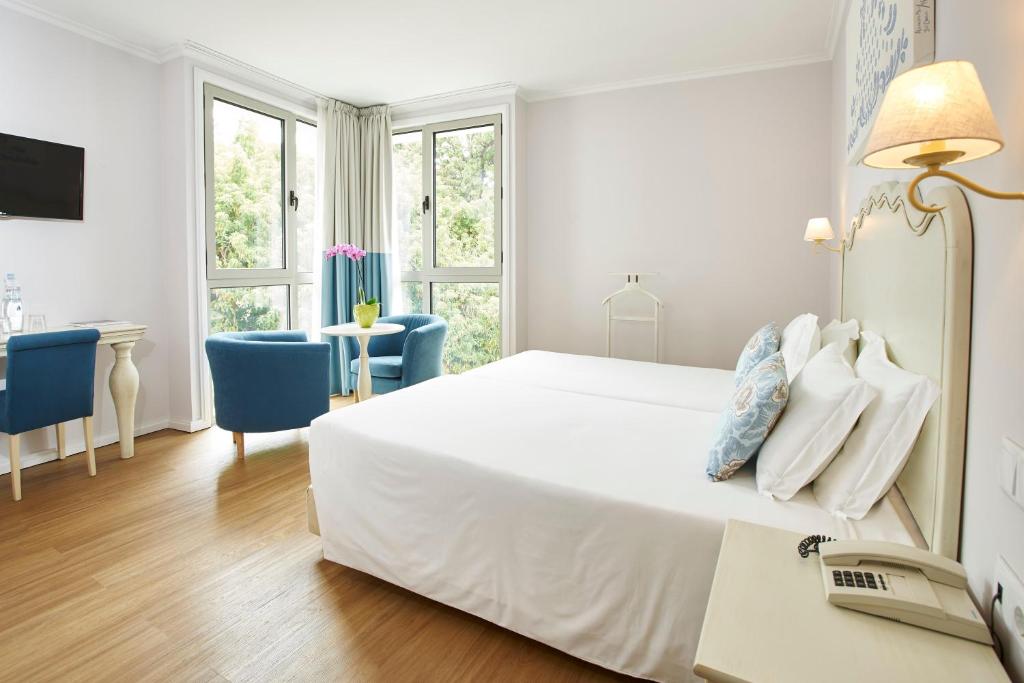 Postel nebo postele na pokoji v ubytování Hotel Madeira