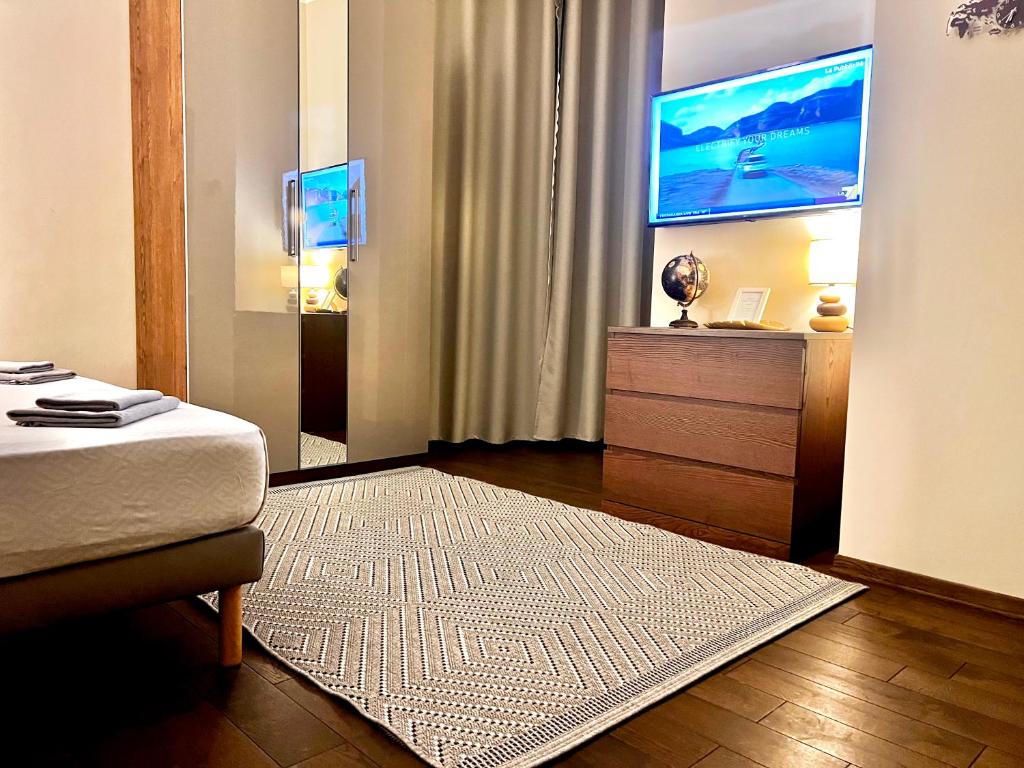 a hotel room with a bed and a television at Italy Vacation Rental in Trieste