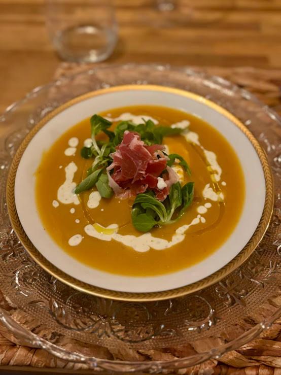 a plate of food on a glass plate on a table at Le Mas Victoria - Chambres d'hôtes avec table d'hôtes-Parking privé ferme in Carcassonne