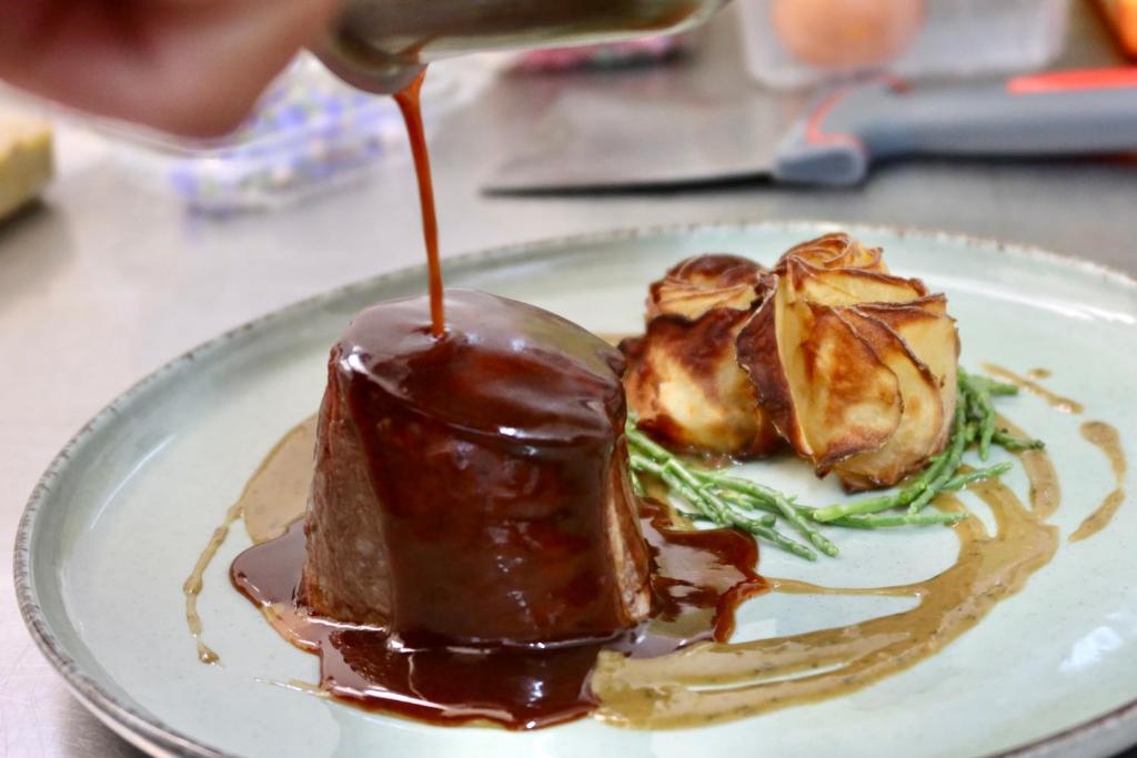 a plate of food with chocolate sauce on it at Boutique Hôtel Château Beaupin Restaurant & Wellness in Marseille