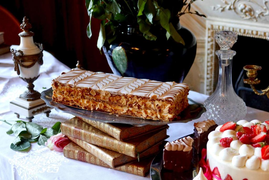 a table topped with a cake and a pile of desserts at Boutique Hôtel Château Beaupin Restaurant & Wellness in Marseille