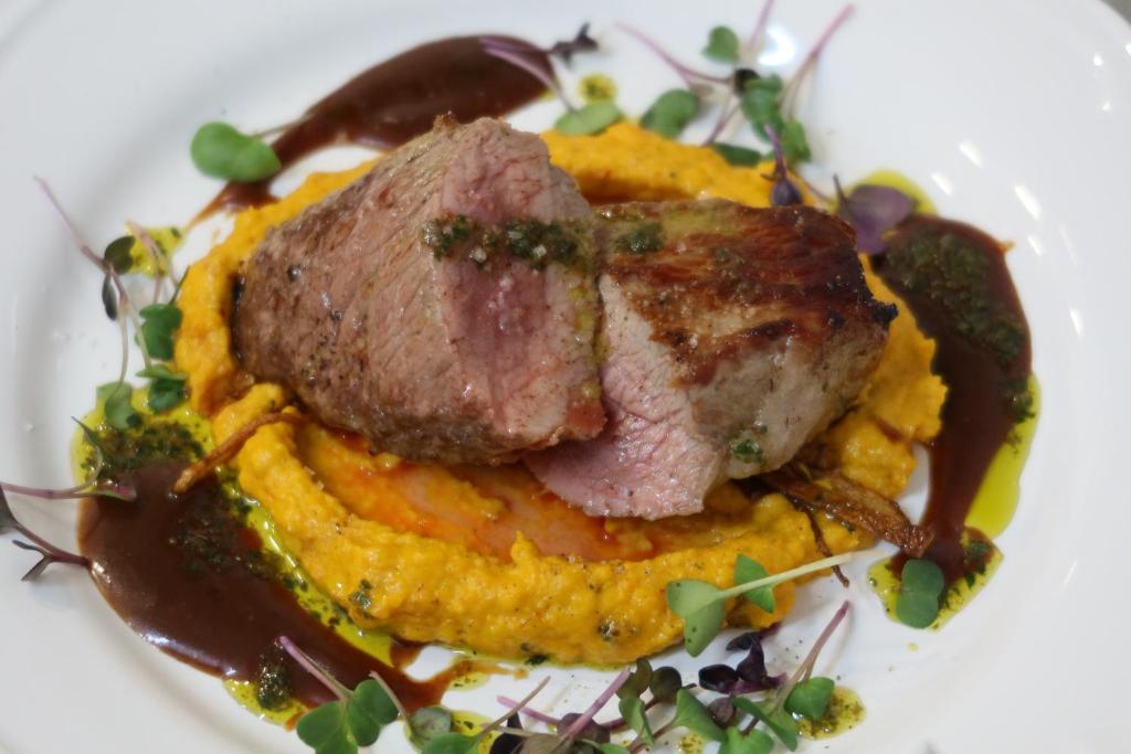a plate of food with a piece of meat and sauce at Boutique Hôtel Château Beaupin Restaurant & Wellness in Marseille