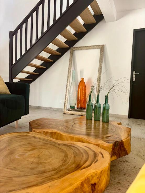 a room with a wooden table with bottles on it at Le Mas Victoria - Chambres d'hôtes avec table d'hôtes-Parking privé ferme in Carcassonne