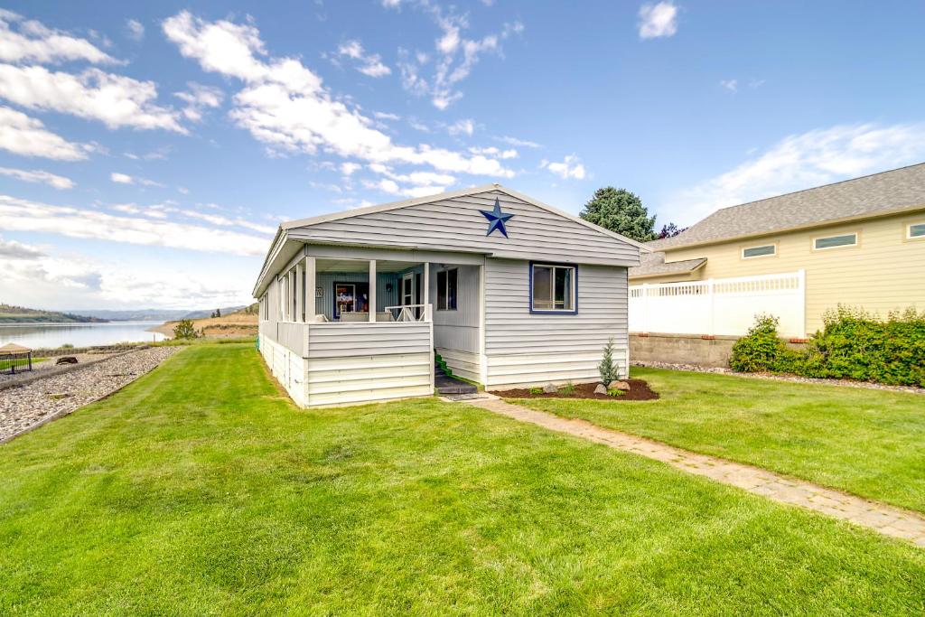 a small white house with a star on it at Seven Bays Vacation Rental on Lake Roosevelt! in Seven Bays