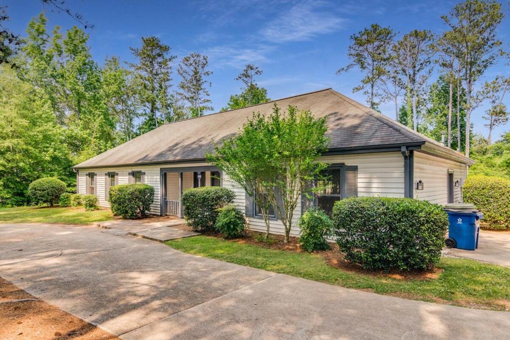 a white house with a gambrel roof at Luxury Poolside 4BR Sanctuary, Sleeps 8 in Conyers