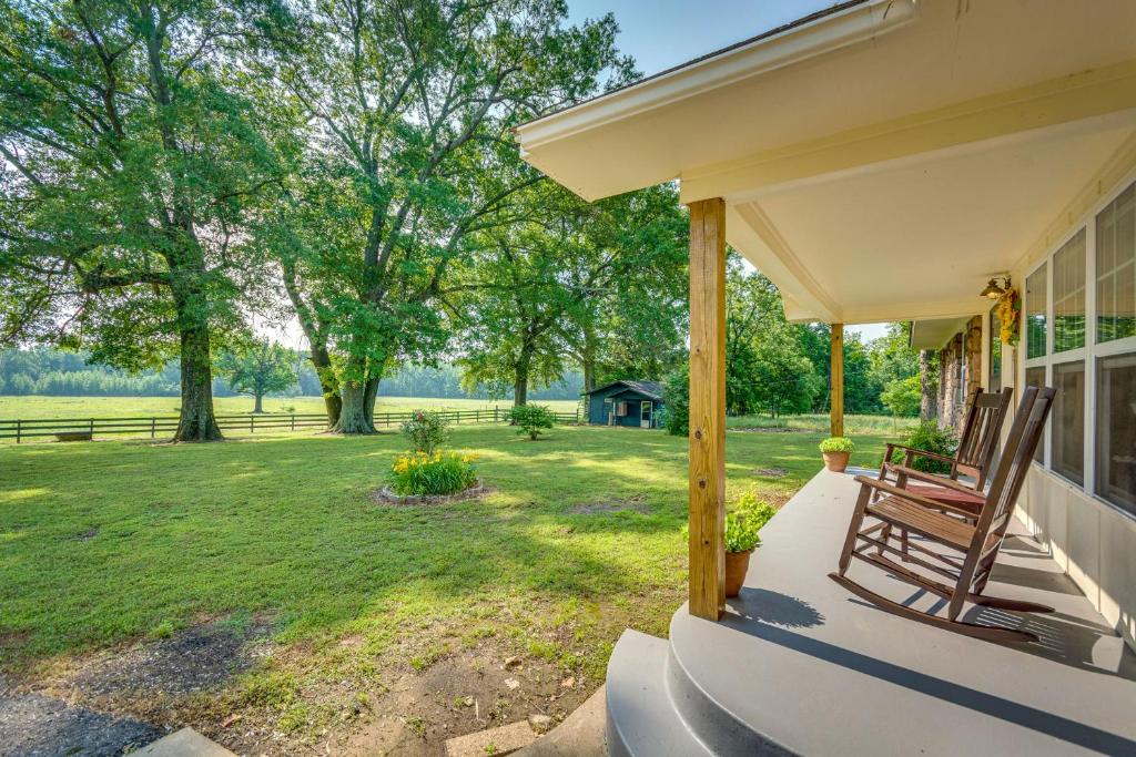 Un porche de una casa con un banco y un patio. en Delaware Vacation Rental Walk to Lake Dardanelle!, en Delaware