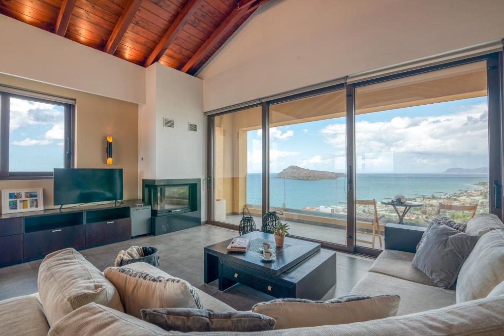 a living room with a couch and a tv at VenMar luxury house in Plataniás
