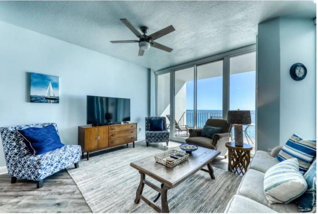 a living room with a couch and a tv at Lighthouse 1115 Condo on the beach 3BR 3BA in Gulf Shores