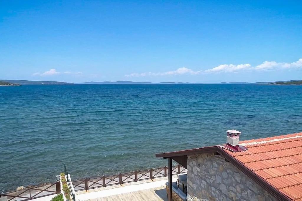 a view of the ocean from a house with a red roof at Urla Sunrise House in Ildır