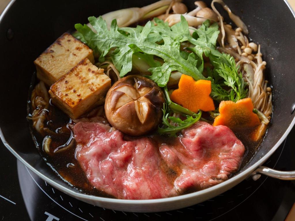 a pan full of food with meat and vegetables at ZIPANG - Vacation STAY 20291v in Matsue