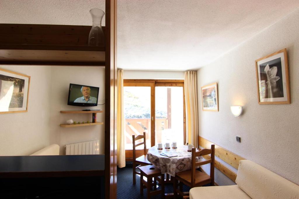 un salon avec une table et une salle à manger dans l'établissement Résidence Temples Du Soleil Machu - VAL THORENS 2 PIECES 4 PERSONNES PLEIN SUD ET AU PIED DES PISTES MAE-7651, à Val Thorens