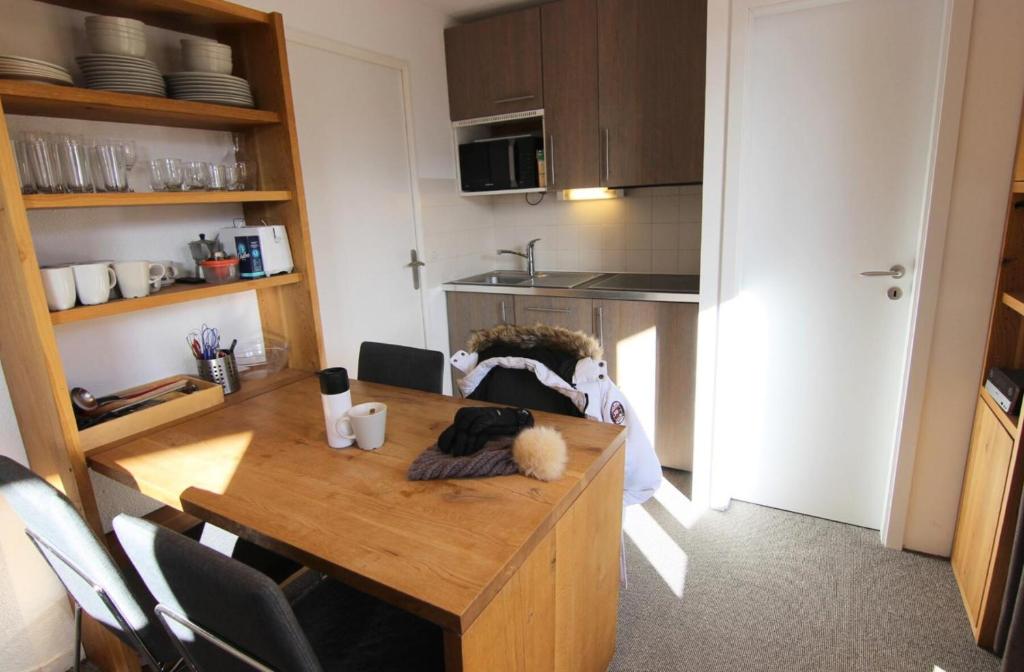 une cuisine avec une table et un animal rembourré dans l'établissement Résidence Reine Blanche - APPARTEMENT CHARMANT ET BIEN EQUIPE POUR 4 PERSONNES ENTREE DE STATION MAE-7702, à Val Thorens