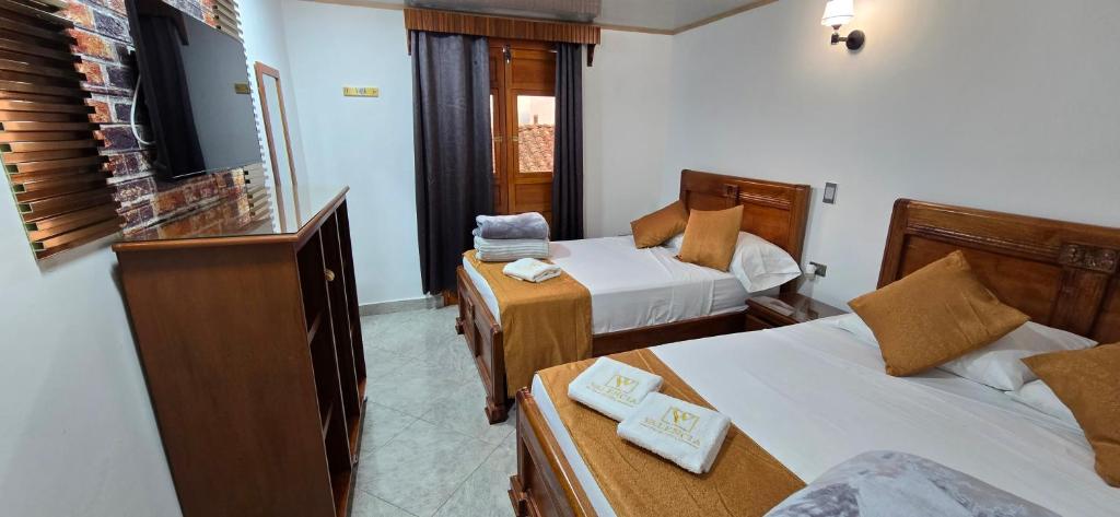 Postel nebo postele na pokoji v ubytování HOTEL EL VALENCIA
