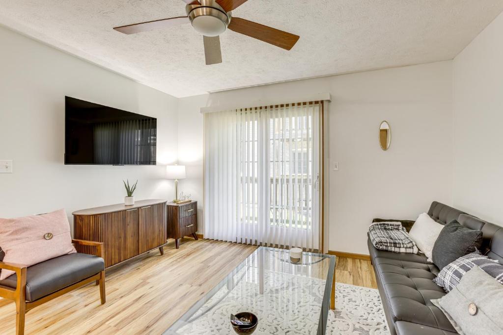 a living room with a couch and a ceiling fan at 3 Mi to WVU Condo with Deck in Morgantown in Morgantown