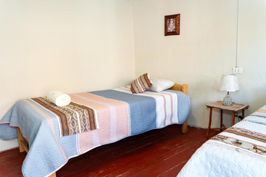 Postel nebo postele na pokoji v ubytování Munay Tika house