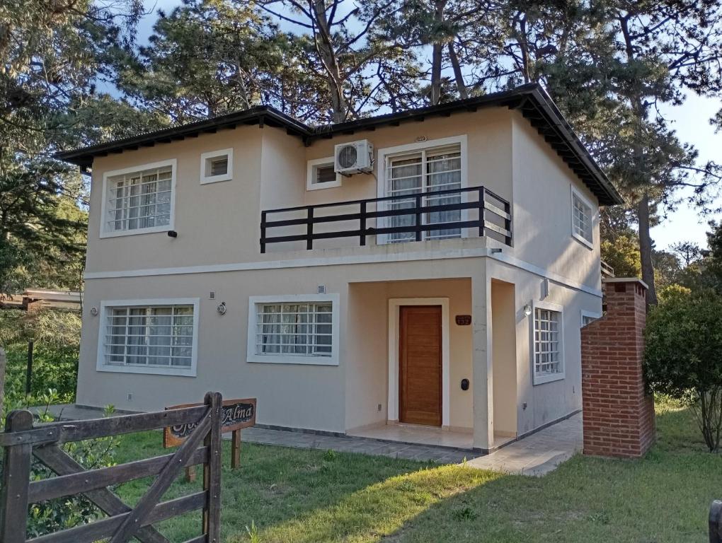 a large white house with a porch at Departamentos Ojos del Alma in Valeria del Mar