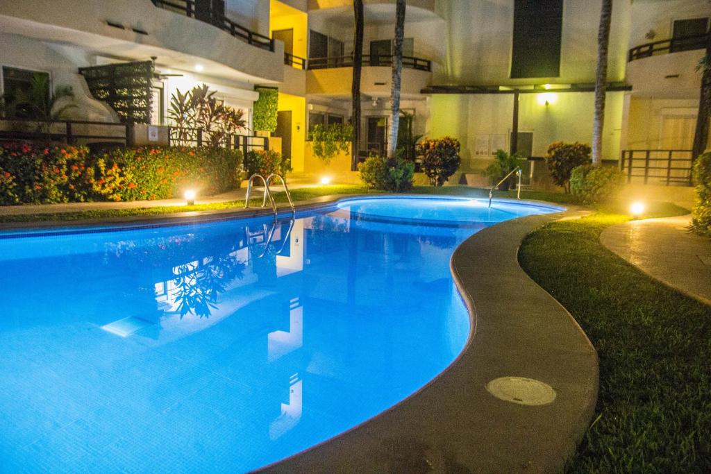 a large swimming pool in a building at night at Creuza de Mä in Playa del Carmen
